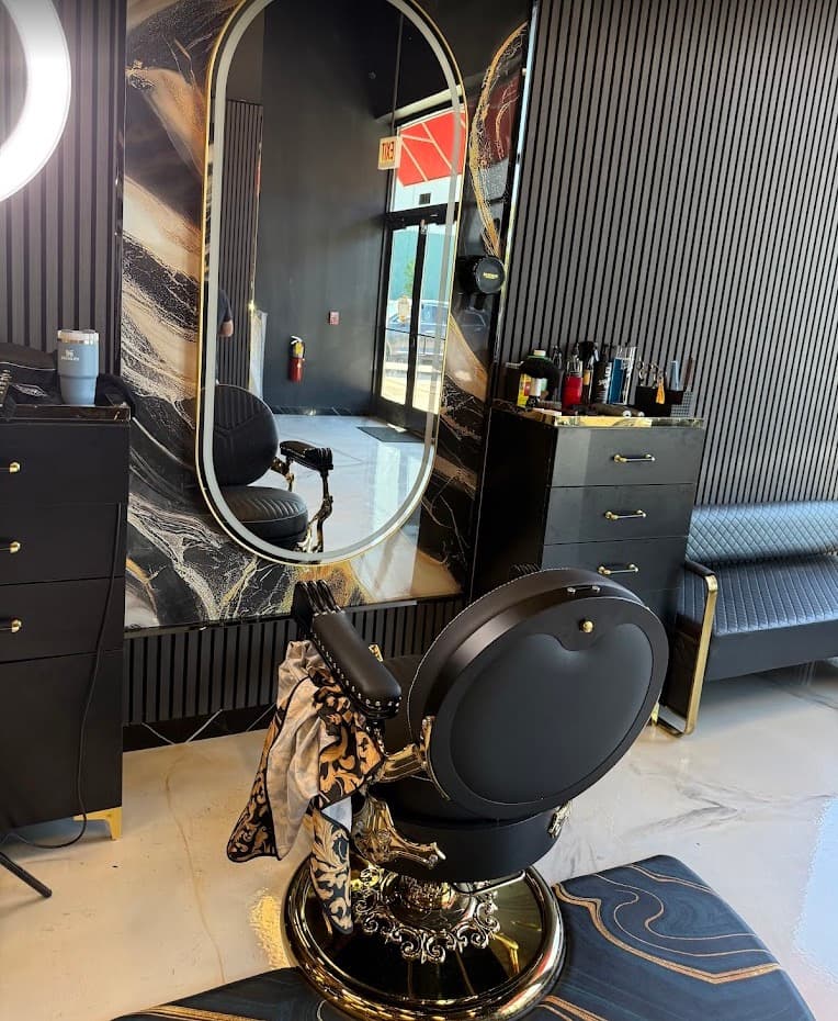 Gold barber chair with marble backdrop